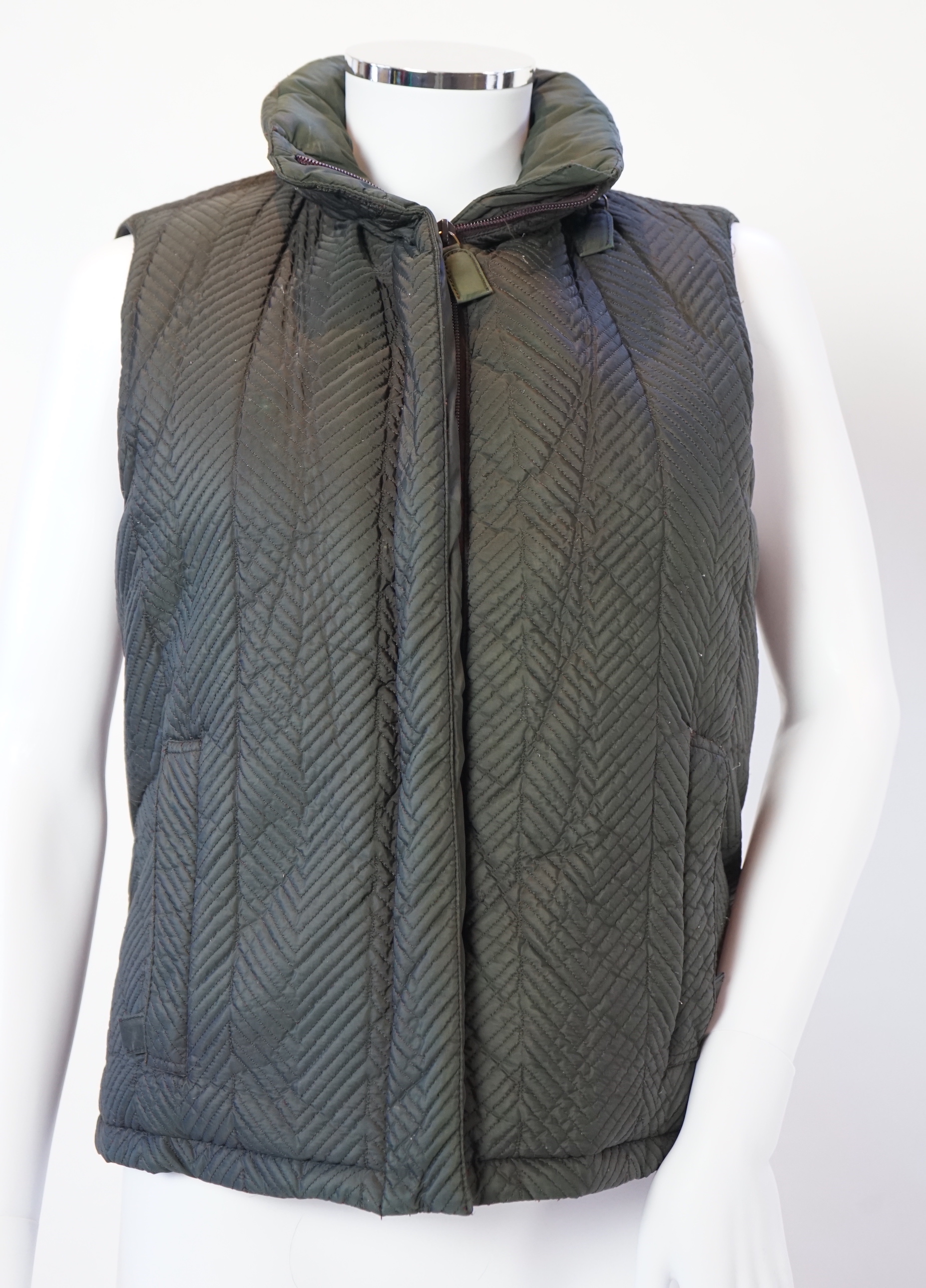 A Prada quilted olive green and brown lady's gilet with hood in collar, size M
